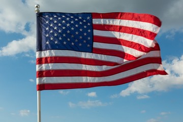 American Flag Waving Against Blue Sky