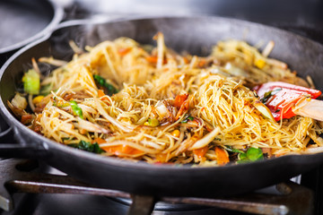 Process of cooking of sweet and crunchy stir fry with beansprouts and noodles in the wok, Macro image
