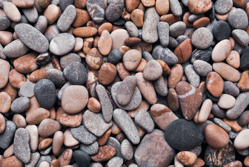 Multicolored colorful sea pebbles, natural background, texture. Close-up texture of colorful sea pebbles. Small Rock. Sea background