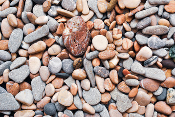 Multicolored colorful sea pebbles, natural background, texture. Close-up texture of colorful sea pebbles. Small Rock. Sea background