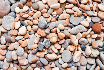 Multicolored colorful sea pebbles, natural background, texture. Close-up texture of colorful sea pebbles. Small Rock. Sea background