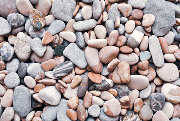 Multicolored colorful sea pebbles, natural background, texture. Close-up texture of colorful sea pebbles. Small Rock. Sea background