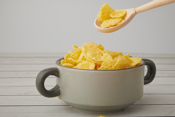 Rolled oats, healthy breakfast cereal oat flakes in bowl on wooden table