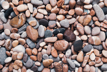 Multicolored colorful sea pebbles, natural background, texture. Close-up texture of colorful sea pebbles. Small Rock. Sea background