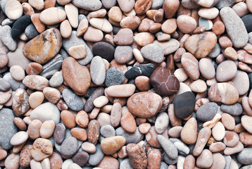 Multicolored colorful sea pebbles, natural background, texture. Close-up texture of colorful sea pebbles. Small Rock. Sea background