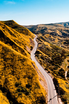 Aerial view of road through yellow mountains