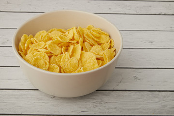 Rolled oats, healthy breakfast cereal oat flakes in bowl on wooden table