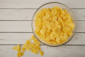 Rolled oats, healthy breakfast cereal oat flakes in bowl on wooden table