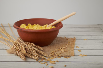 Rolled oats, healthy breakfast cereal oat flakes in bowl on wooden table