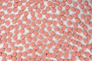 Orange colour round pills on white  background with selective focus. Pills that look like ecstasy