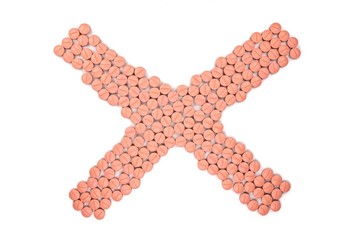 Orange colour round pills on white  background with selective focus. Pills that look like ecstasy