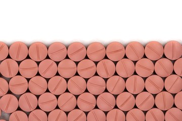 Orange colour round pills on white  background with selective focus. Pills that look like ecstasy