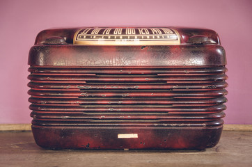 Real old vintage radio with pink colorful background