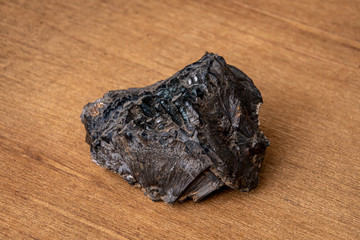 Brown limonite on black gemstone gem jewel mineral precious stone on wooden underground