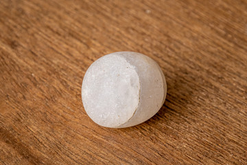 Round small gravel of sandstone washed round by the waves of the sea on wooden underground