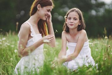 bride and groom sitting on grass in the park