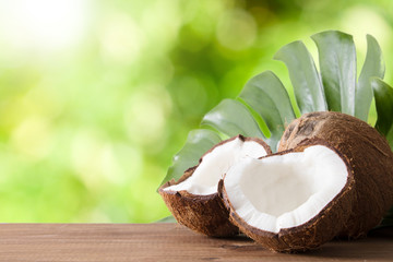 open natural coconut with green background, tropical fruit
