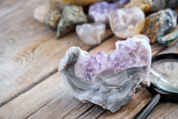 Mineral stones collection. Amethyst with agate and magnifying glass in the foreground.