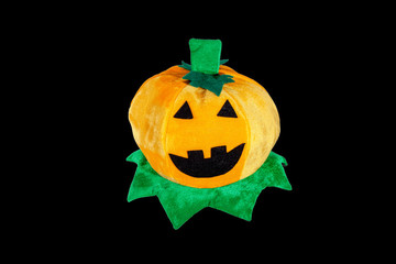 Pumpkin on the head. Hat in the form of a pumpkin for the Halloween holiday on a black background