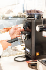 Coffee machine and barista preparing coffee in a cafe shop