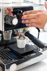Fototapeta na wymiar Coffee machine and barista preparing coffee in a cafe shop