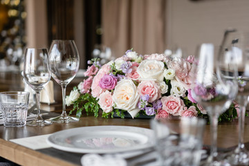 Wine glasses in the foreground. Wedding Banquet or gala dinner. The chairs and table for guests, served with cutlery and crockery.