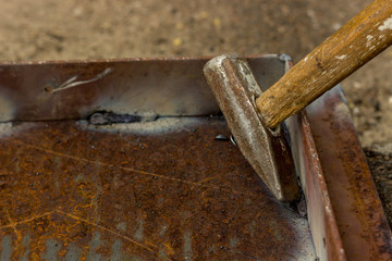 Weld seams on rusty metal. The metal corner is welded to the iron base.
