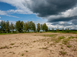 Beautiful, calm lake shore with storm clouds, wonderful reflections, Lake Burtnieks, Latvia