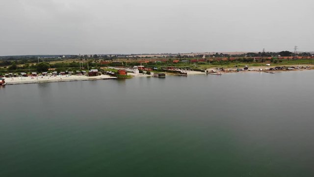 Trains going on railroads near the bay.