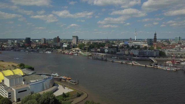 Scenic panorama from the musical halls of Hamburg over the harbor with Landungsbruecken, ships and boats on river Elbe, and the TV tower