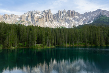 Fototapeta na wymiar Beautiful view of Lago di Carezza with mountain reflections in the water. Trentino-Alto Adige, Italy