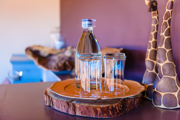 Glasses and a bottle of water in an African game lodge, Namibia