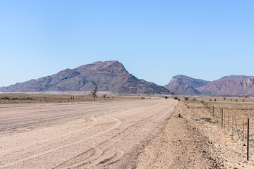 Fototapeta na wymiar Dirt gravel road through the Naukluft Mountain Park, Namibia