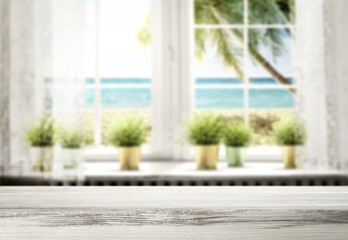 Table background and white window with ocean and beach view. Blank space for product