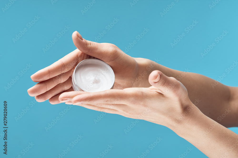 Wall mural hand with cream isolated on white background