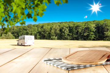 Wooden table background in the beautiful forest mountains view in distance. Blank space for your product.