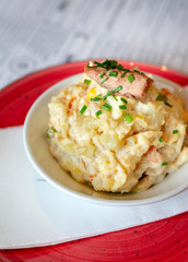 Spanish potato salad on red plate.
