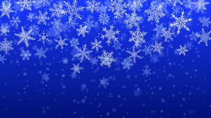 Christmas background of complex blurred and clear falling snowflakes in blue colors with bokeh effect