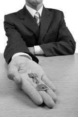 Portrait of a Businessman Showing a Key