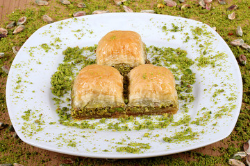 the best turkish baklava Fresh and delicious pistachios together with pistachios on a white plate big close up
