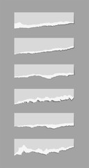 Torn sheets of paper. A set of torn paper and strips of paper on a dark background. Vector illustration.