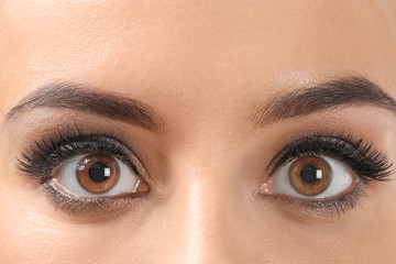 Beautiful young woman with eyelash extensions, closeup