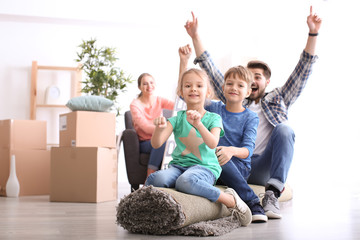 Father playing with children indoors. Happy family on moving day