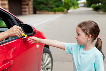 Stranger in the car offers candy to the child. Kids in danger. Children safety protection. Children...