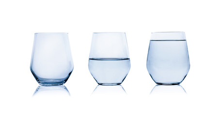 Empty, half and full glasses of water on white background