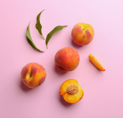 Flat lay composition with fresh peaches on pink background
