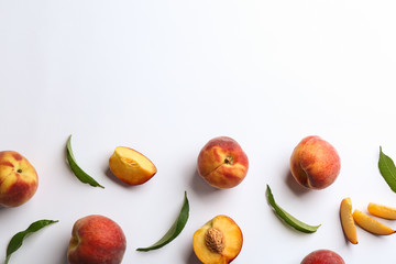 Composition with fresh peaches on white background, top view
