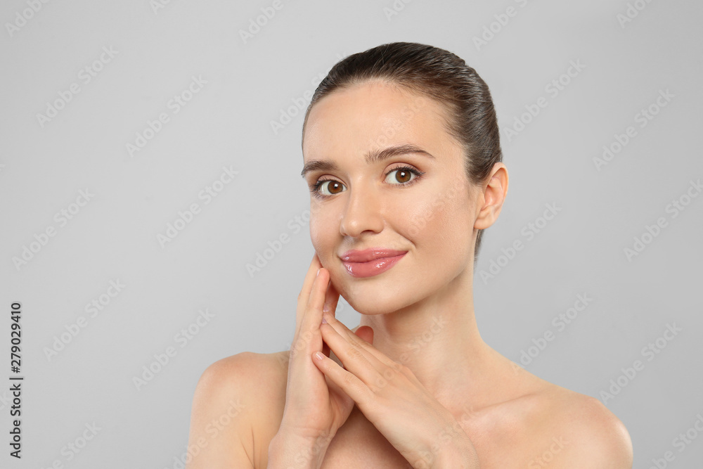 Canvas Prints Portrait of beautiful young woman with perfect skin on grey background. Spa treatment