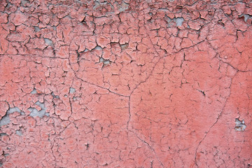 Texture of a concrete wall with cracked paint. Texture of a crumbling wall for the background in design. The basis for the banner