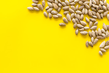 Healthy snack with almonds on yellow background top view mock up